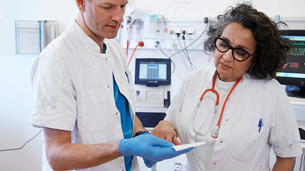 Doctor and nurse checking results. ABL90 FLEX blood gas analyzer in the background